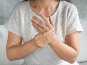 A woman massaging her wrist