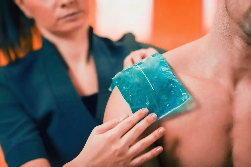 An ice pack being applied to a shoulder