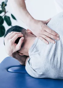 A chiropractor working on a man's back