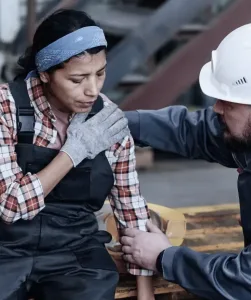 A worker giving aid to an injured coworker