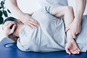 A chiropractor working on a man's back