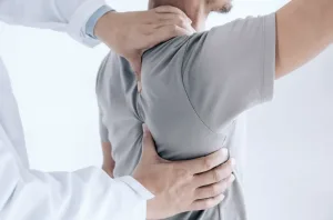 A doctor examining a man's back